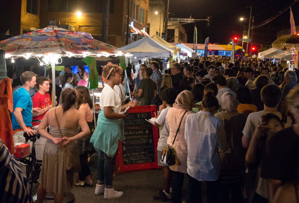 Image of Little Mekong Night Market. Crowded street of people and vendors.